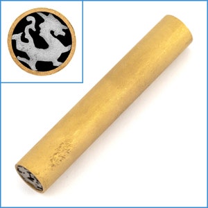 May include: A cylindrical, brass-colored object with a circular inset. The inset features a black background with a white and gray abstract design. The main object is a solid, golden-yellow color.