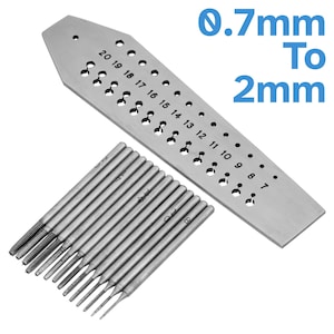 May include: A set of 15 drill bits ranging in size from 0.7mm to 2mm, along with a metal gauge with numbered holes for measuring the drill bits. The gauge is labelled "0.7mm To 2mm".