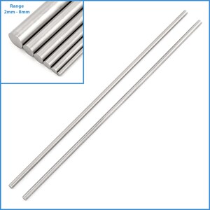May include: Two silver metal rods, each measuring 8 inches in length. The rods are parallel to each other and are lying on a white surface. The image also shows a close-up of a set of silver metal rods of varying diameters, ranging from 2mm to 8mm.