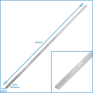 May include: A silver metal bar measuring 3 inches wide, 3 inches thick, and 200 millimetres long.