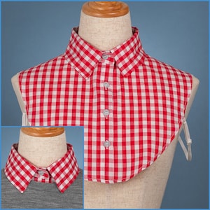 May include: Red and white gingham fabric collar with a rounded shape and ties. The collar is made of a soft, lightweight fabric and is perfect for adding a touch of style to any outfit.