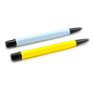 May include: Two cleaning tools with black handles and wire brushes. One tool has a light blue handle and the other has a yellow handle.