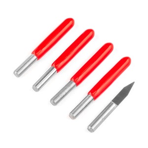 May include: Five carving tools with red handles and silver blades, and one carving tool with a silver handle and a black blade.