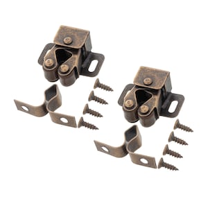 May include: Two antique brass cabinet door catches with two screws each and two metal brackets.