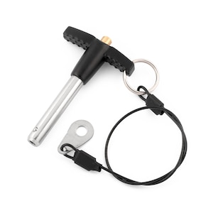 May include: A black and silver T-handle pin with a black cord and a silver ring. The pin is attached to the cord with a black plastic clip.