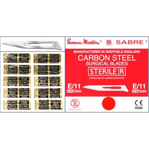 May include: A pack of sterile, single-use carbon steel surgical blades labeled Swann-Morton Sabre E/11, manufactured in Sheffield England. The blades are sterilized by gamma radiation and have a red circle on the packaging.