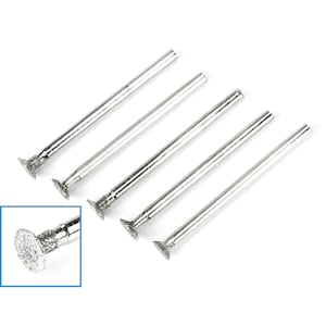 May include: Five silver diamond tipped grinding bits for a rotary tool. The bits are shaped like a small cone with a flat base. The bits are shown on a white background.