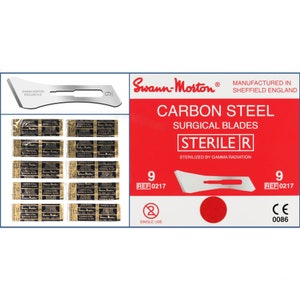 May include: A pack of 9 sterile carbon steel surgical blades, labelled Swann-Morton, manufactured in Sheffield England. The blades are individually packaged and labelled with the reference number 0217. The packaging is red and white with the text "STERILE R" and "STERILIZED BY GAMMA RADIATION".