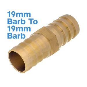 May include: A brass 19mm barb to 19mm barb fitting. The fitting has a hexagonal center section and ribbed ends for secure hose connections. The text "19mm Barb To 19mm Barb" is in blue.