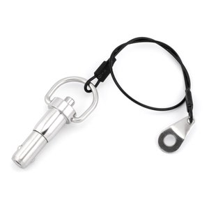 May include: A silver quick release pin with a black cord and a loop on the end. The pin has a small loop on the top for attaching to a lanyard.