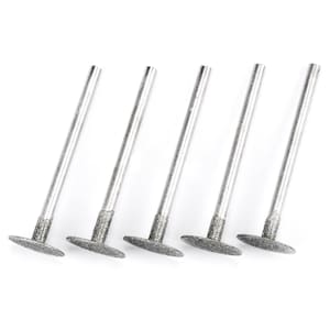 May include: Set of five silver-colored diamond-coated grinding bits with a flat, oval-shaped head. Each bit has a long, thin shaft.