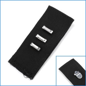 May include: Black fabric strap with three silver metal loops. The strap is approximately 12.7 cm long.