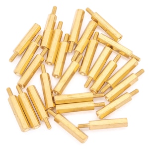 May include: A pile of 20 gold-coloured metal standoffs. The standoffs are hexagonal in shape and have a threaded end.