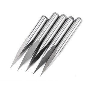 May include: Five silver-coloured, pointed router bits with a sharp, angled tip. The bits are arranged in a fan shape, with the tips pointing towards the right.