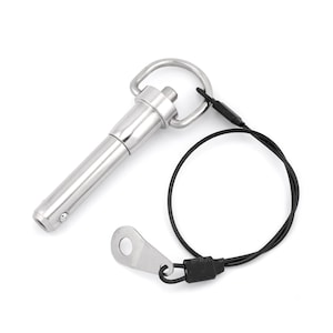 May include: A silver quick release pin with a black tether. The pin has a loop on one end and a spring-loaded button on the other end.