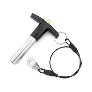 May include: A black and silver quick release pin with a T-shaped handle and a black cord attached to a ring.