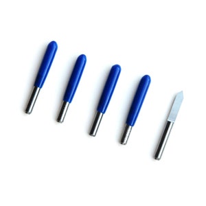 May include: Five blue and silver craft knives with a single silver craft knife.