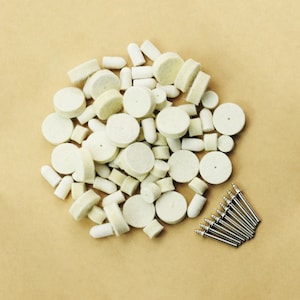 May include: A large pile of white felt polishing wheels and a set of ten silver metal polishing mandrels.