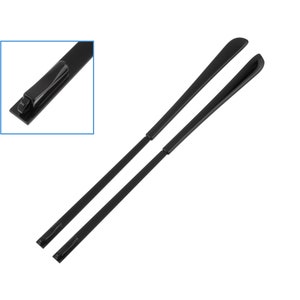 May include: A pair of black plastic replacement temple arms for eyeglasses. The arms are designed to be attached to the frame of the glasses.