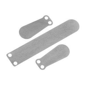 May include: Three silver metal pieces with rounded edges and holes. The pieces are different sizes and shapes.