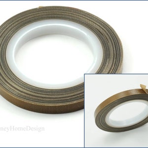 May include: A roll of brown heat-resistant tape with a white backing. The tape is wound into a circle and has a textured surface.