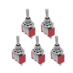 May include: Five silver toggle switches with red plastic bases. The switches have a round, silver knob on top.
