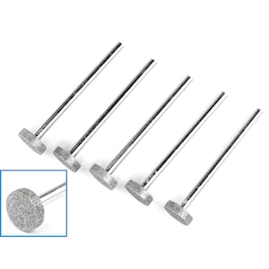 May include: Set of six silver-colored diamond-coated grinding bits with a round head. The bits are used for grinding and polishing.