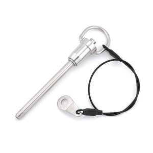 May include: A silver metal clevis pin with a loop on the end and a black cord attached. The pin is about 5 inches long.