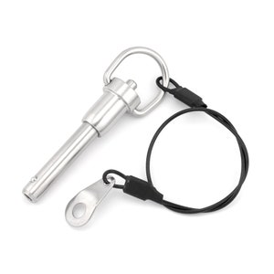 May include: A silver quick release pin with a loop on the end and a black cord attached to the loop.