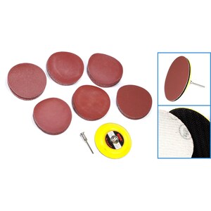May include: Set of 7 sanding discs for a rotary tool. The set includes 6 brown sanding discs and 1 yellow sanding disc with a black center. The sanding discs are 2 inches in diameter. The set also includes a metal shaft.