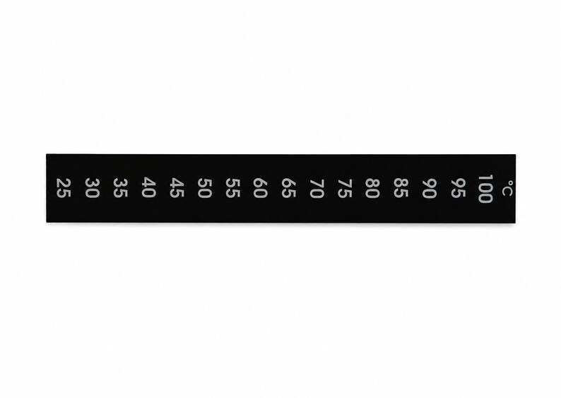 May include: A rectangular black temperature strip featuring white printed numbers ranging from 25 to 100, followed by the symbol &deg;C. The strip is designed for monitoring heat levels and displays clear, evenly spaced numerical increments for reading.