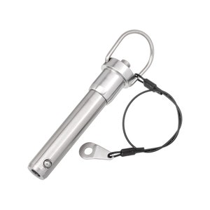 May include: A stainless steel quick release pin with a ring handle and a black wire lanyard. The pin has a cylindrical body with a button on the side and a small, flat tab attached to the lanyard.