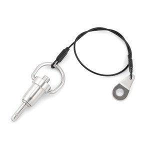 May include: A silver quick release pin with a black cord and a loop on the end. The pin has a small loop on the top and a spring-loaded pin.
