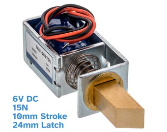 May include: A silver and brass magnetic door lock with red and black wires. The lock has a 10mm stroke and a 24mm latch. The label on the lock reads "TAU-0837DL 6VDC 10mm 15N".