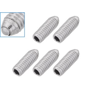 May include: Six silver-toned, round-headed screws with a hexagonal drive. The screws have a threaded shaft and a rounded head with a small ball bearing at the tip.