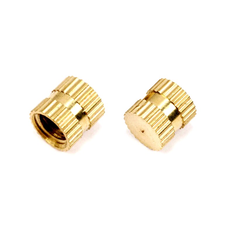 May include: Two gold-colored threaded inserts with a knurled outer surface. The inserts are designed for use in plastic or wood.
