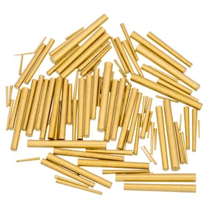 May include: A collection of various-sized brass dowels, arranged against a white background. The dowels are cylindrical, with a consistent golden color. The sizes vary from short, thin pins to longer, thicker rods.