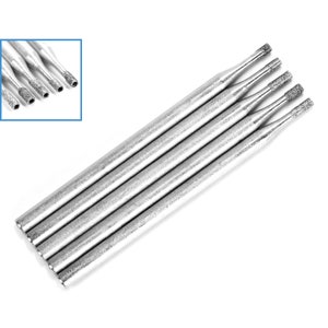 May include: Five silver diamond tipped drill bits, arranged in a row, with the tips facing the camera.