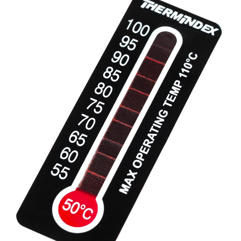 May include: Black and white thermometer with a red indicator showing a maximum operating temperature of 110 degrees Celsius. The thermometer has a red circle with the text "50&deg;C" on it.
