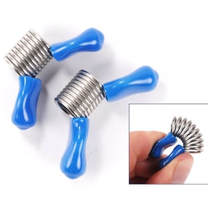 May include: Two blue and silver spring-loaded finger exercisers. The exercisers are made of metal and have a blue plastic handle. The exercisers are shown in a variety of positions.