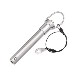 May include: A silver metal clevis pin with a loop on one end and a spring-loaded pin on the other end. A black cord with a metal loop is attached to the pin.