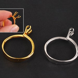 May include: Two ring settings, one gold and one silver, for setting stones or other jewellery components. The settings are open and ready to be closed around a ring band.