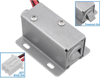 May include: A silver electric door lock with a rectangular shape and a small, rectangular opening on the side. The lock has two screws on the top and a JST XH2.54 connector. The lock is powered on and the latch is retracted.