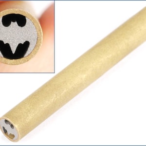 May include: A gold-colored metal pen with a Batman logo design on the end.
