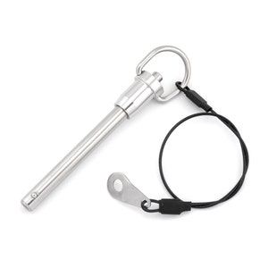 May include: A silver metal pin with a loop and a black cord. The pin has a spring-loaded mechanism and a small ring on the end. The cord is attached to the loop and has a black plastic end cap.