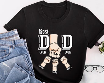 May include: Black t-shirt with white text that reads "Best Dad Ever" with a large fist in the middle of the text. Three smaller fists are below the text with the names "Thomas", "Emily", and "Henry" written below each fist.