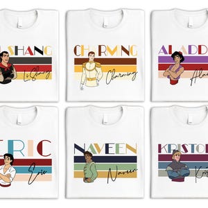 May include: Six white t-shirts with colorful stripes and Disney prince characters. Each shirt features a different prince, including Aladdin, Prince Charming, Naveen, Kristoff, Eric, and Li Shang. The names of the princes are printed on the shirts.