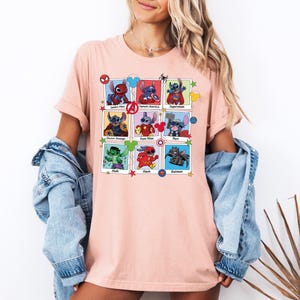 a woman wearing a pink t - shirt with pictures of cartoon characters on it