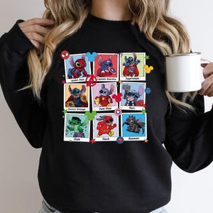 a woman is holding a coffee cup and wearing a black sweatshirt