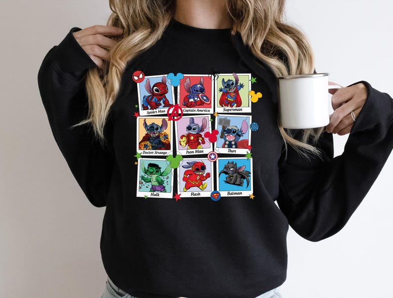 a woman is holding a coffee cup and wearing a black sweatshirt